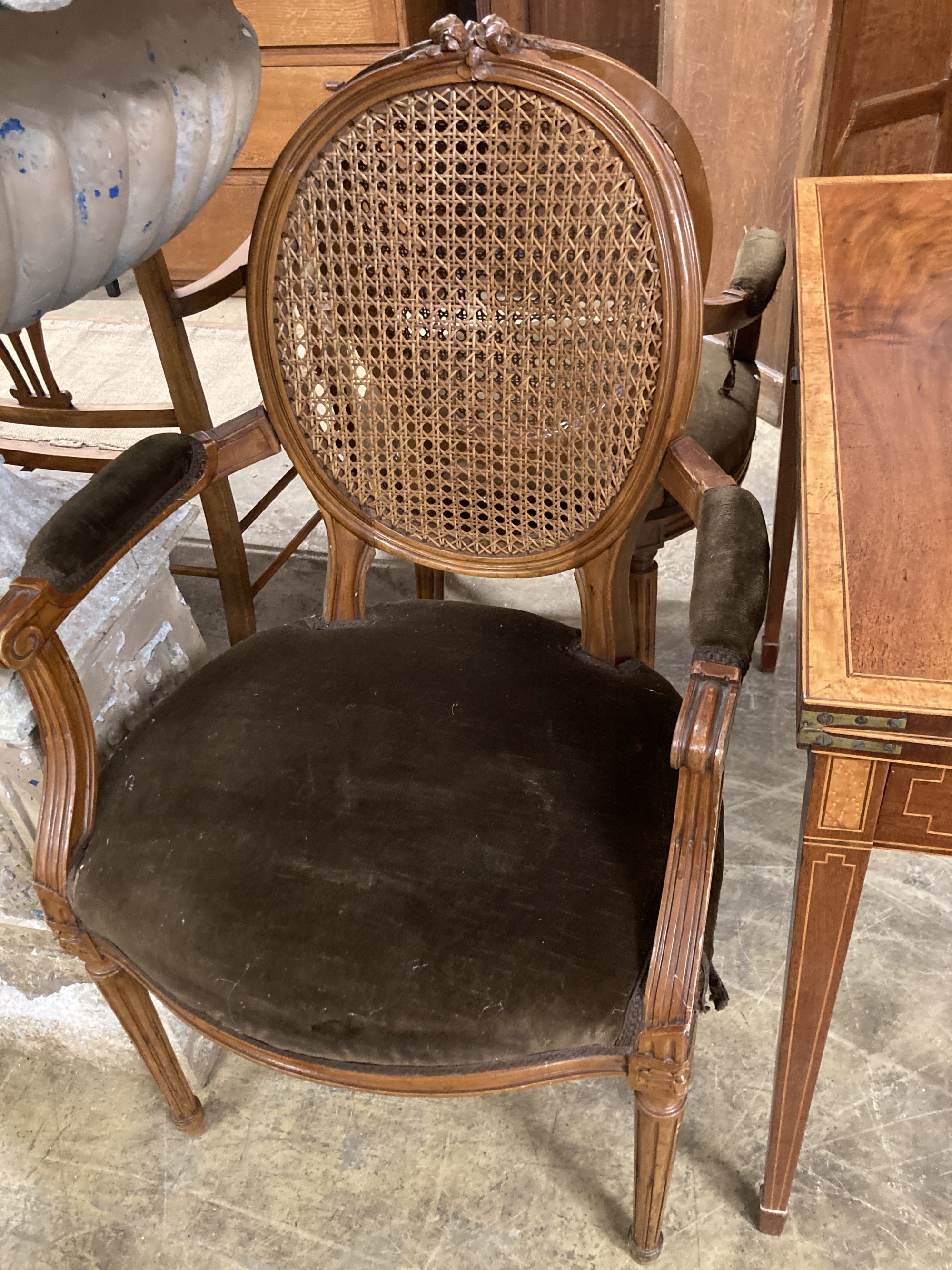 A pair of Louis XVI style caned back fauteuils